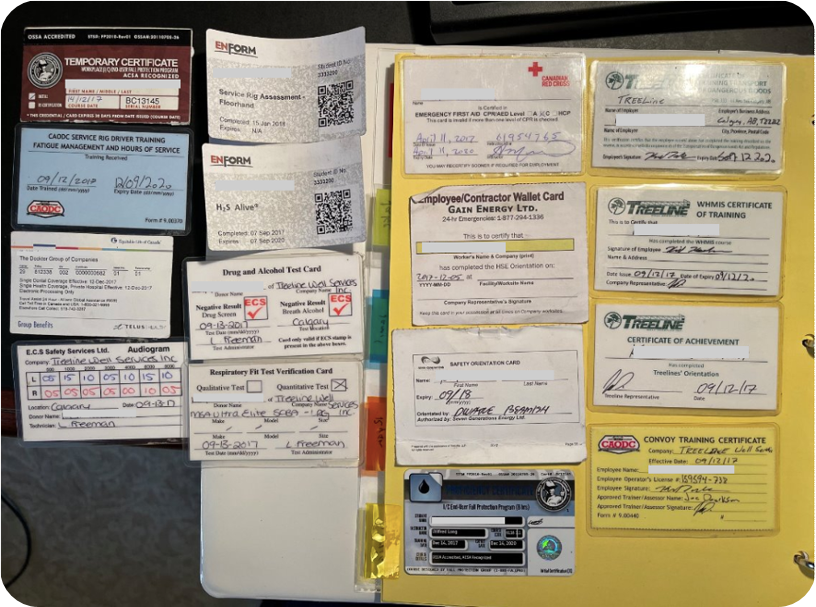 A real worker's binder of paper qualification cards