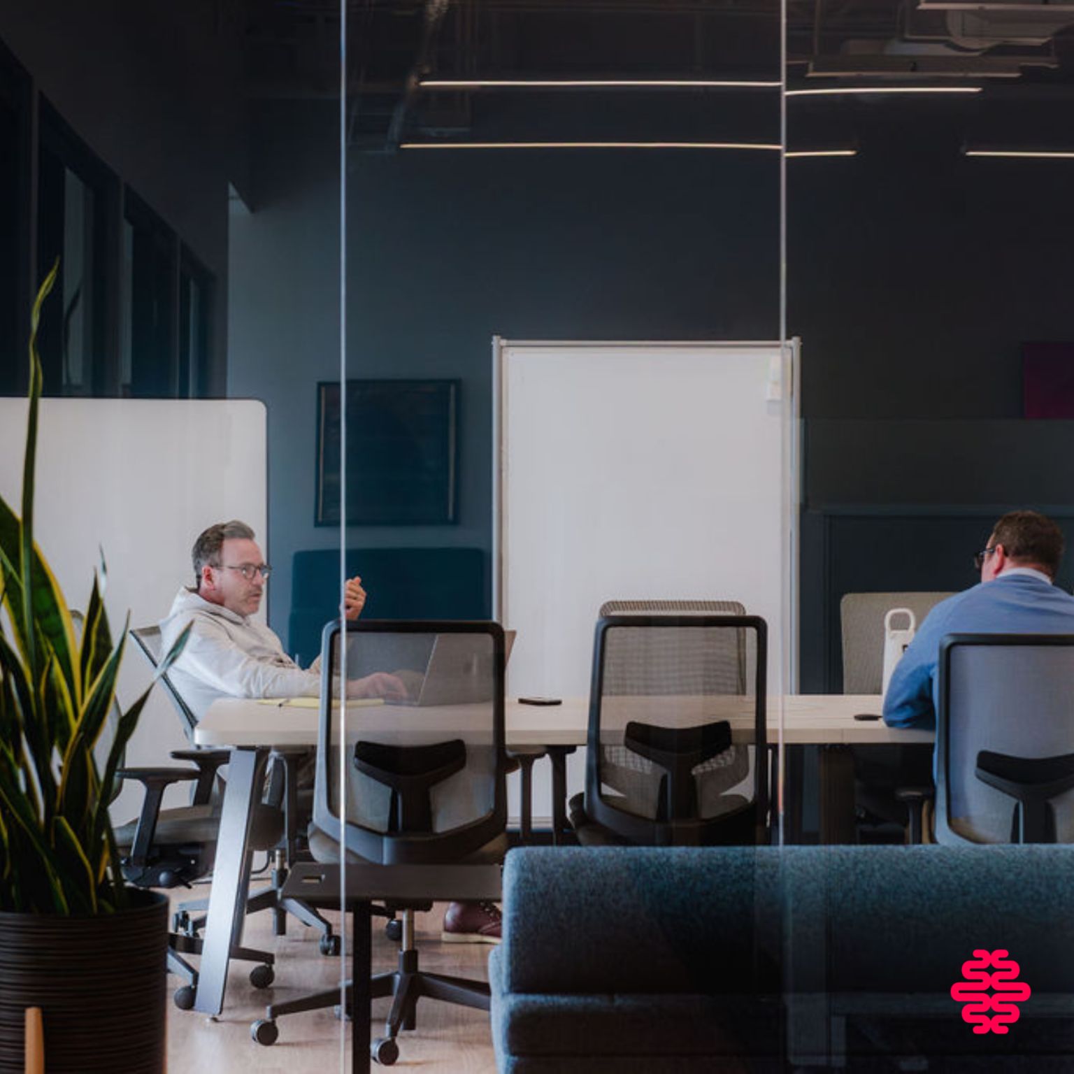 We Know Training Edmonton HQ, team collaborating in glass-walled meeting room